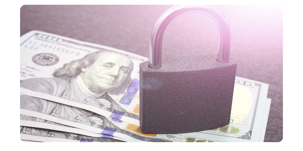 An image of hundred dollar bills with a lock on top