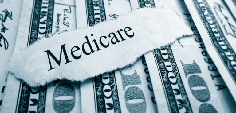 a several 100-dollar bills fanned out with a torn white piece of paper on top with the word "medicate" written out in Times New Roman font