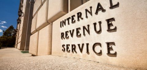 A close-up of a brown building with black metal lettering that says "Internal Revenue Service"