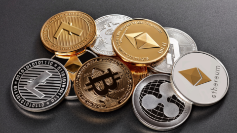 a pile of coins with various cryptocurrency logos engraved into them