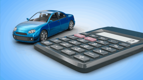 A photo of a calculator a blue toy car next to it.