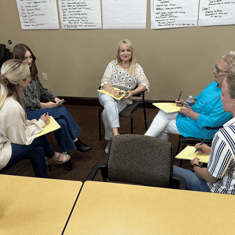 A group of Avizo employees sitting in a semi-circle talking