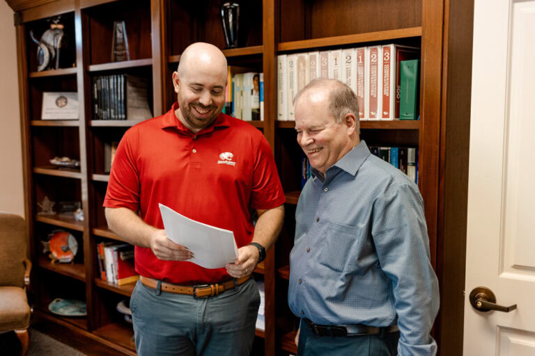 Two Avizo employees review paperwork