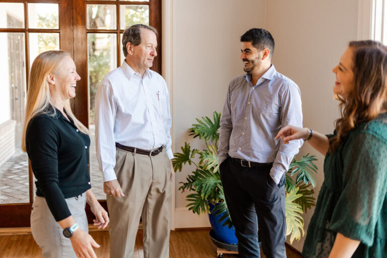 Four Avizo employees engaging in casual conversation