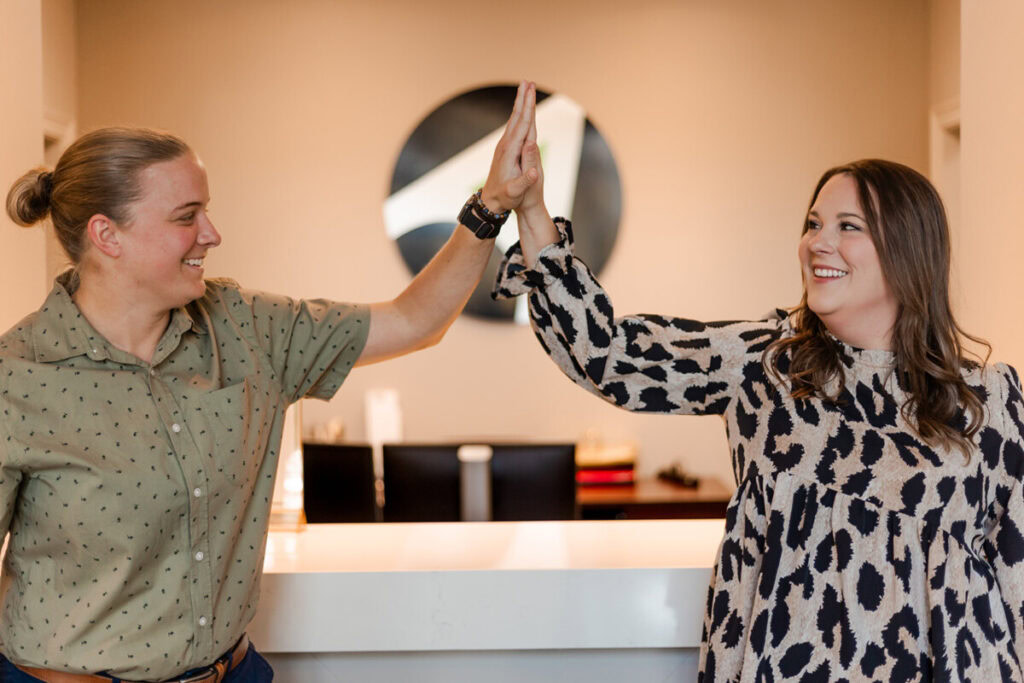 Two Avizo employees high five