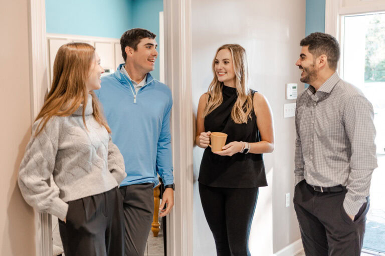 Four Avizo employees engaging in casual conversation