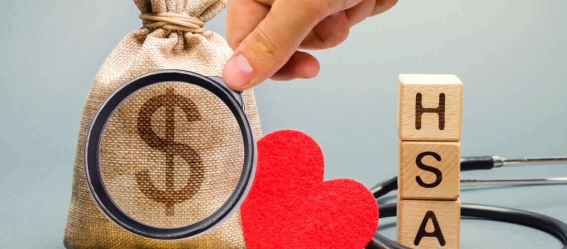 A photo of several items including burlap bag with a money symbol, a heart, a stethoscope, blocks with the letters HSA