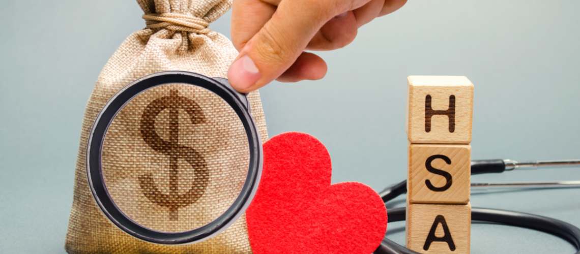 A photo of several items including burlap bag with a money symbol, a heart, a stethoscope, blocks with the letters HSA