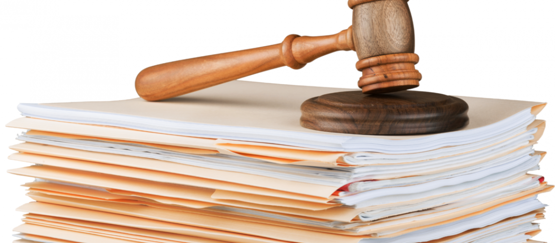 a photo of a stack of photos with a judge's gavel sitting on top