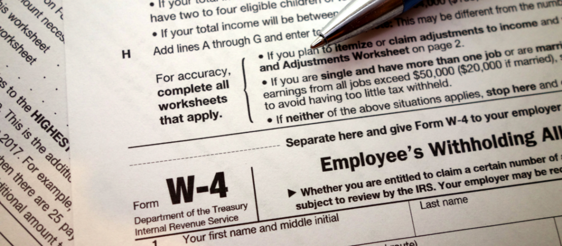 A W-4 form with a pen on top of it