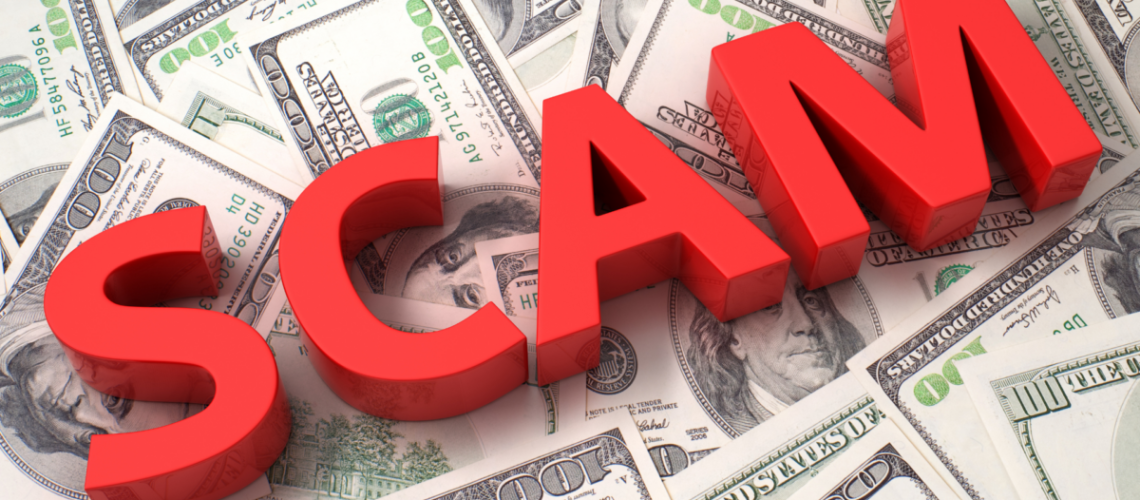 An image of the word SCAM in red blocks laying across money.