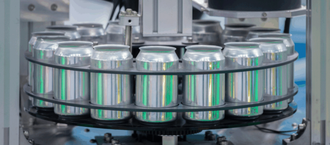 Cans in a machine to be filled with a beverage