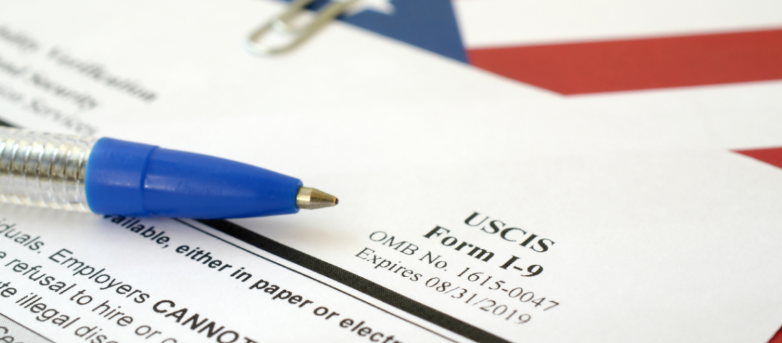 An image of the corner of an I-9 form in front of the American flag.